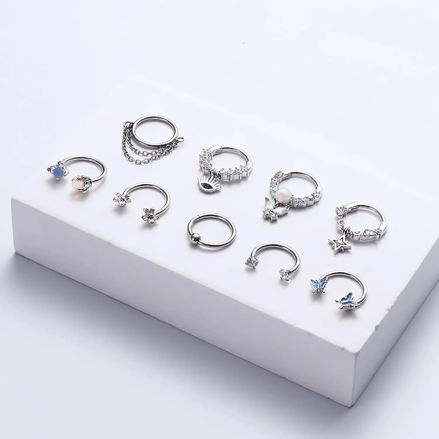 JOERICA 9pc 16G Septum Rings - Small, Dangle & Hoops with Cute, Evil Eye, Butterfly & Flower Designs - Surgical Steel Septum Piercing Jewelry